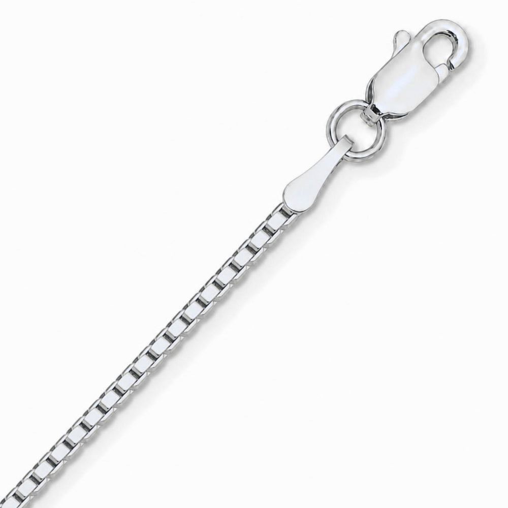 A close up image of a white gold box chain on a pure white background