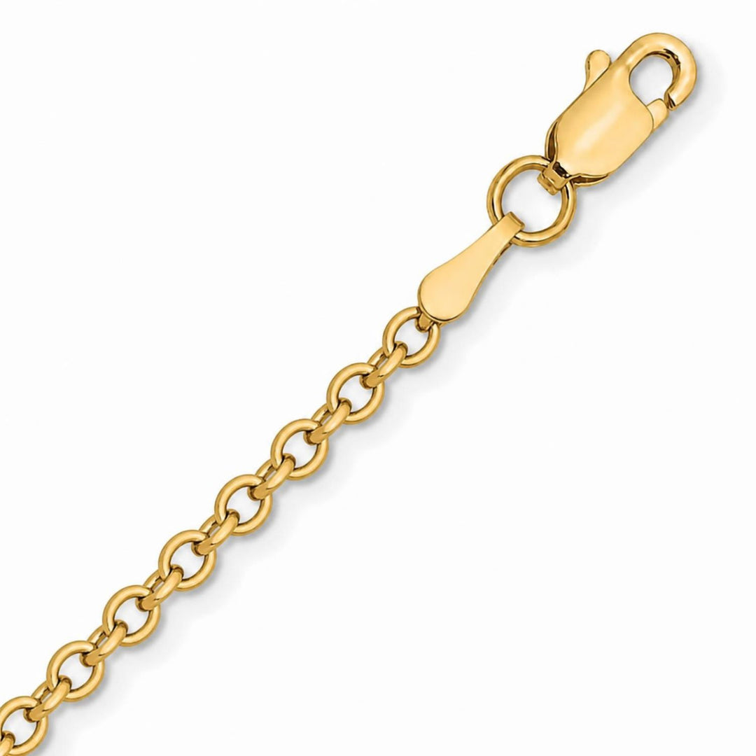 A image showing a close up of a yellow gold cable chain on a white background