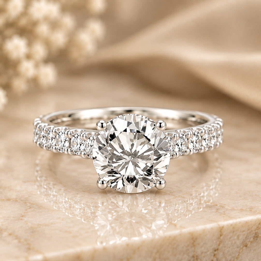 14 karat white gold 3ct round lab grown diamond hidden halo engagement ring with diamond accent band shown from the front on a styled display at AJ's Jewelry in Ridgewood, Queens NY
