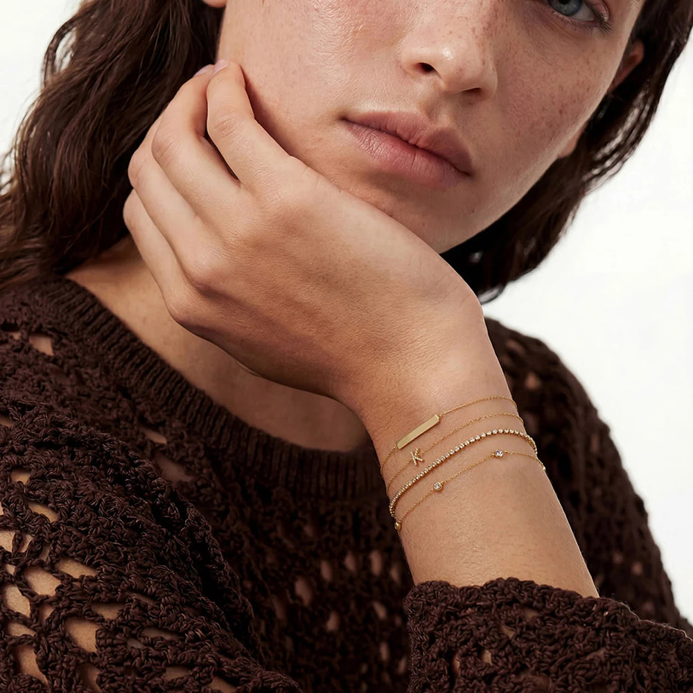 Close-up of the 14K yellow gold bezel-set lab grown diamond station bracelet worn on the wrist | AJ's Jewelry