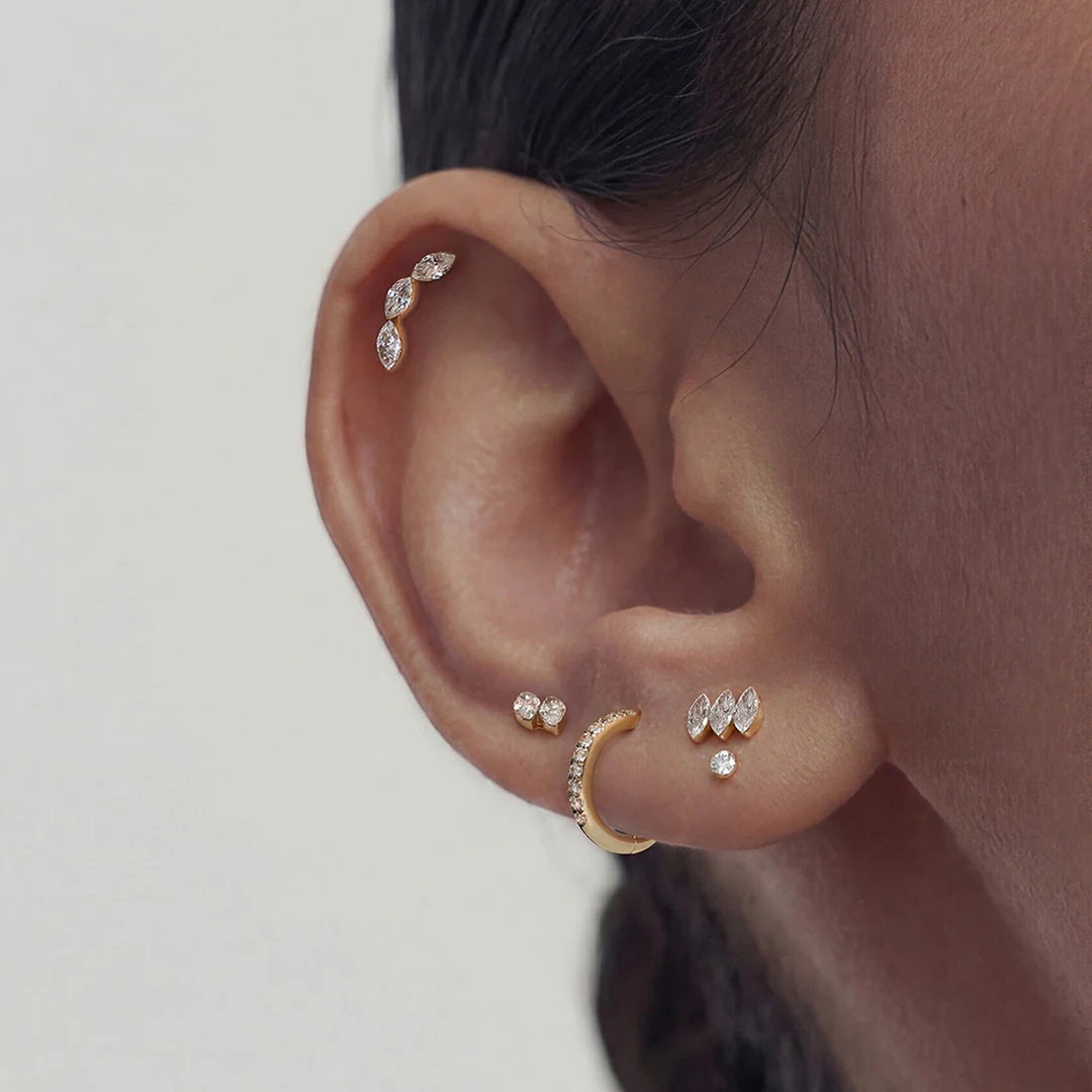 Close-up of the 14K yellow gold curved marquise lab grown diamond flat back stud earrings worn on the ear | AJ's Jewelry