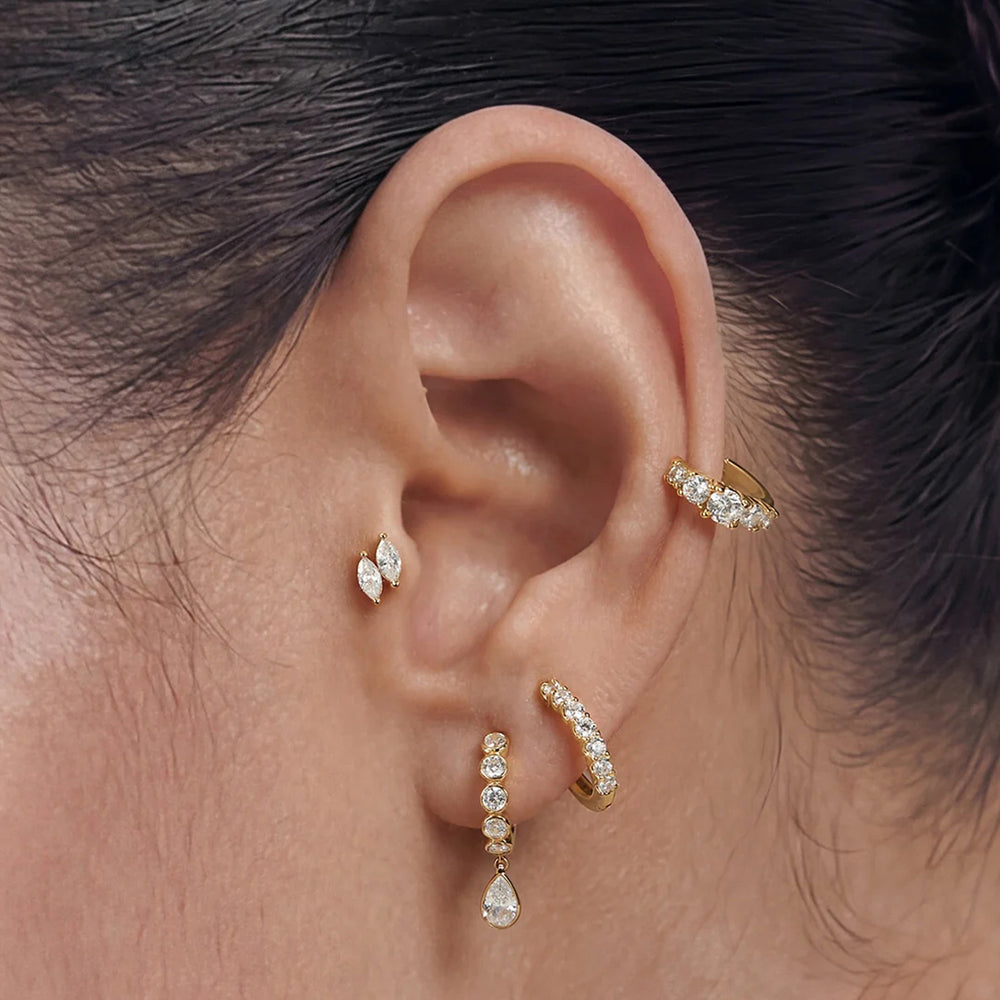 Model wearing the 14K yellow gold double marquise lab grown diamond stud earrings in a styled ear stack | AJ's Jewelry