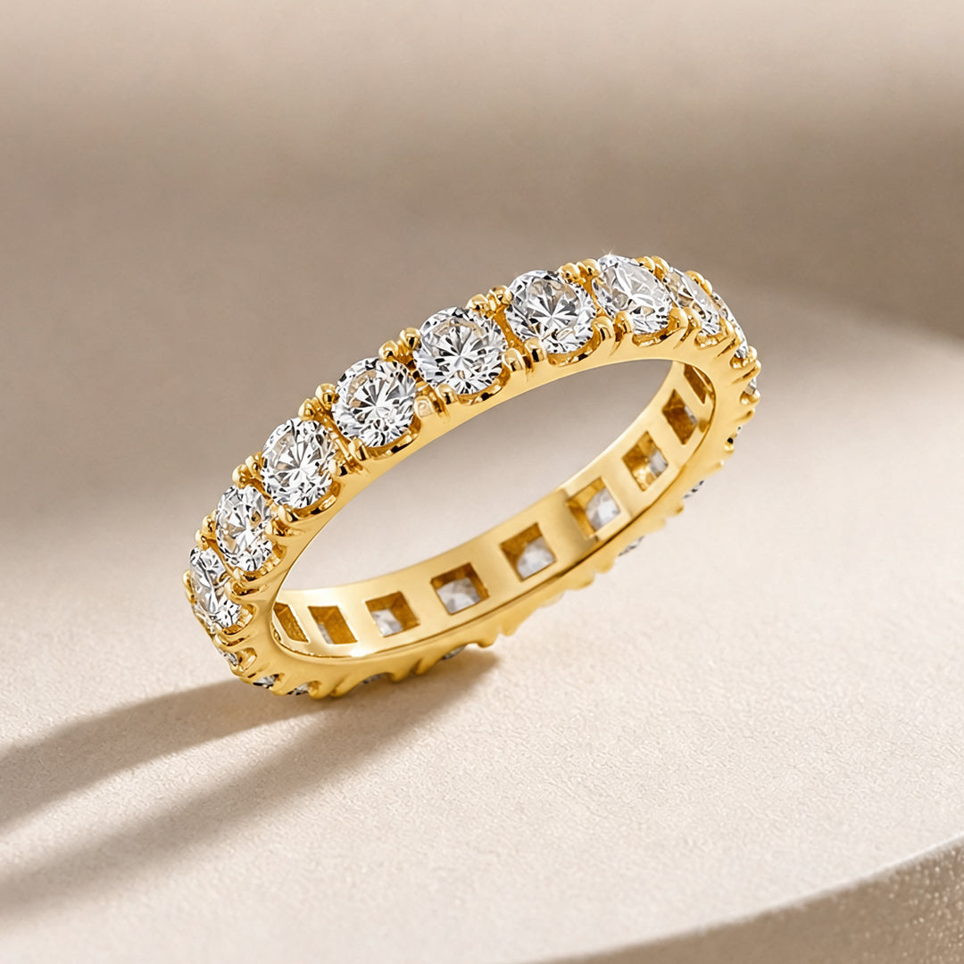 14 karat yellow gold lab grown diamond eternity band shown at an angle on a styled display at AJ's Jewelry in Ridgewood, Queens NY
