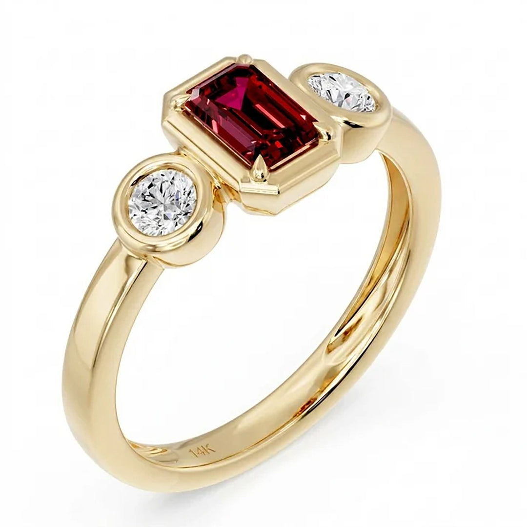 14K yellow gold three-stone bezel ring with an emerald-cut lab grown ruby center and two round lab grown diamonds