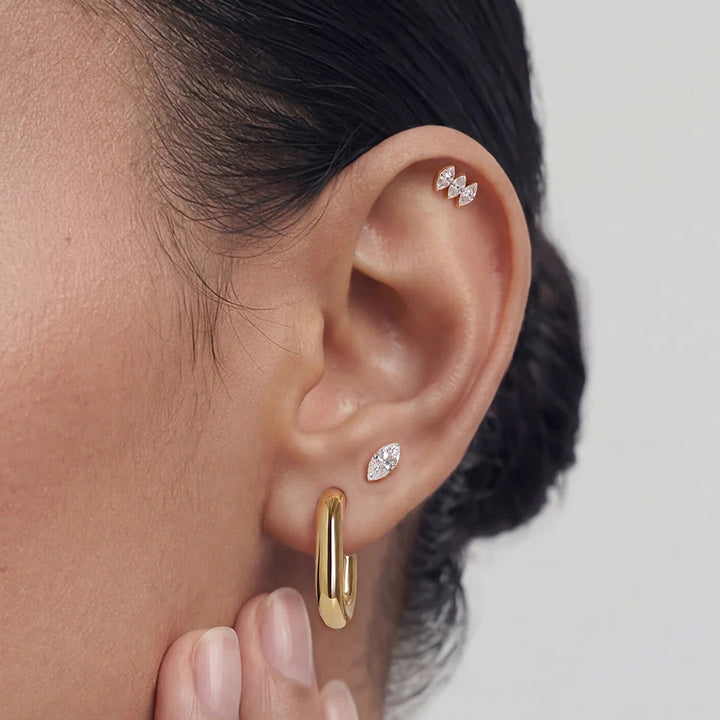 Ear stack featuring the 14K yellow gold marquise lab grown diamond three-stone flat back stud earrings | AJ's Jewelry