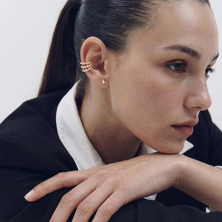 Model wearing the 14K yellow gold pear lab grown diamond stud earrings in a styled ear stack | AJ's Jewelry