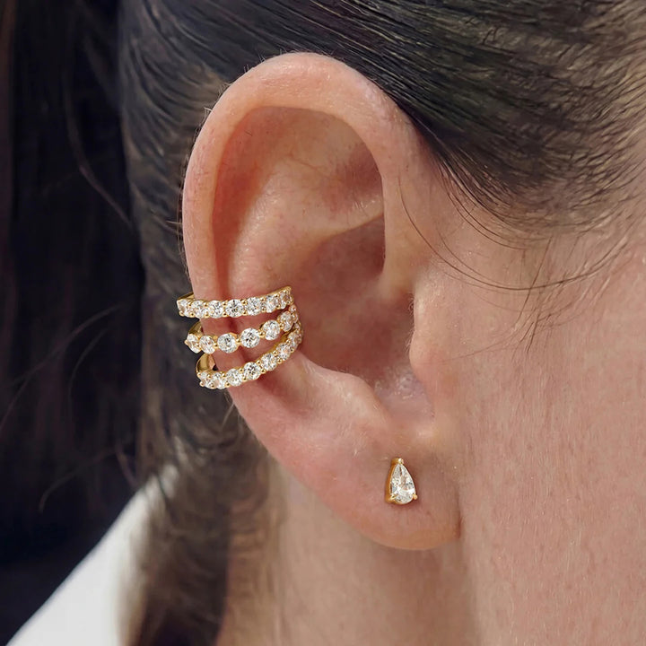 Close-up of the 14K yellow gold pear lab grown diamond stud earrings worn on the ear | AJ's Jewelry