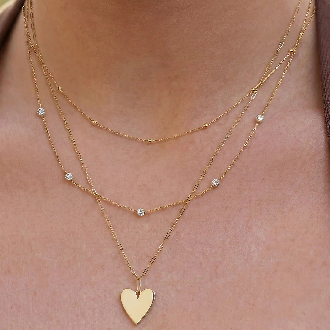 Lifestyle photo of the 14K yellow gold polished heart pendant necklace on a model | AJ's Jewelry
