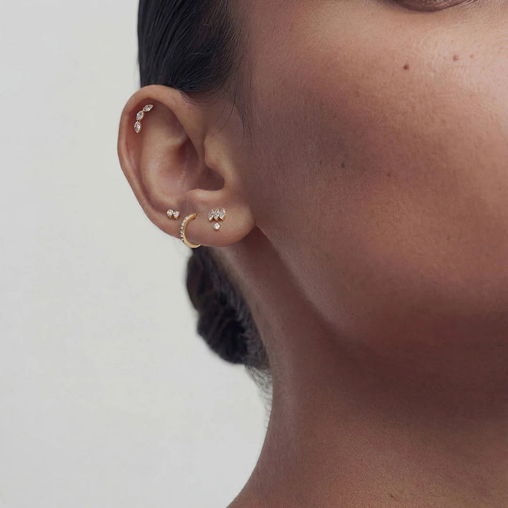 Close-up of the 14K yellow gold twin marquise lab grown diamond flat back stud earrings worn on the ear | AJ's Jewelry