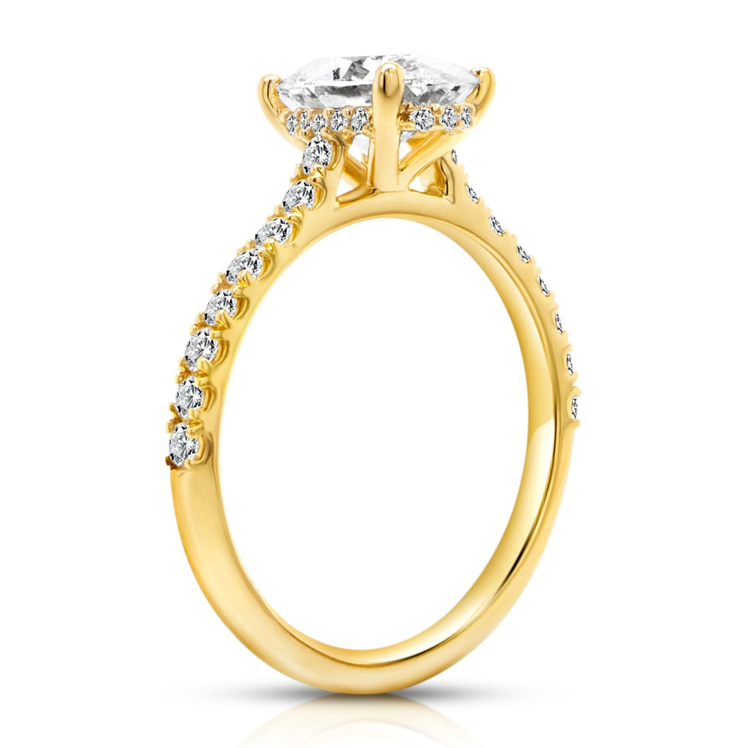 18 karat yellow gold 2ct oval lab grown diamond hidden halo engagement ring with diamond accent band, side profile view