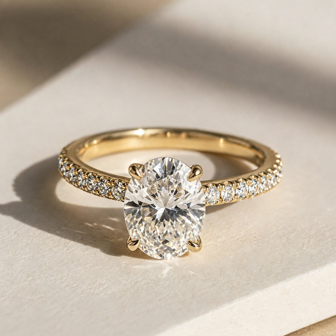 2 carat oval lab grown diamond pave engagement ring from the front on a styled display at AJ's Jewelry Queens NY