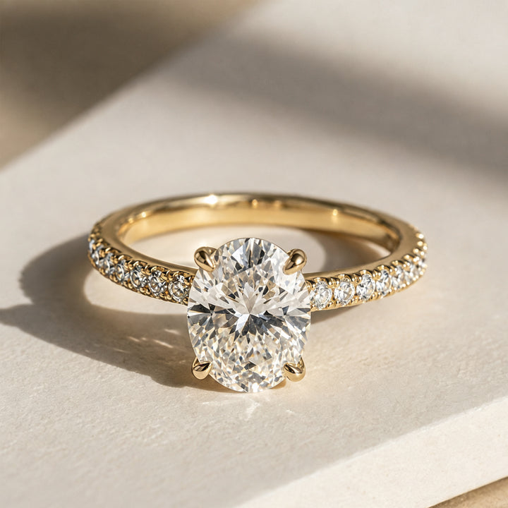 2 carat oval lab grown diamond pave engagement ring from the front on a styled display at AJ's Jewelry Queens NY