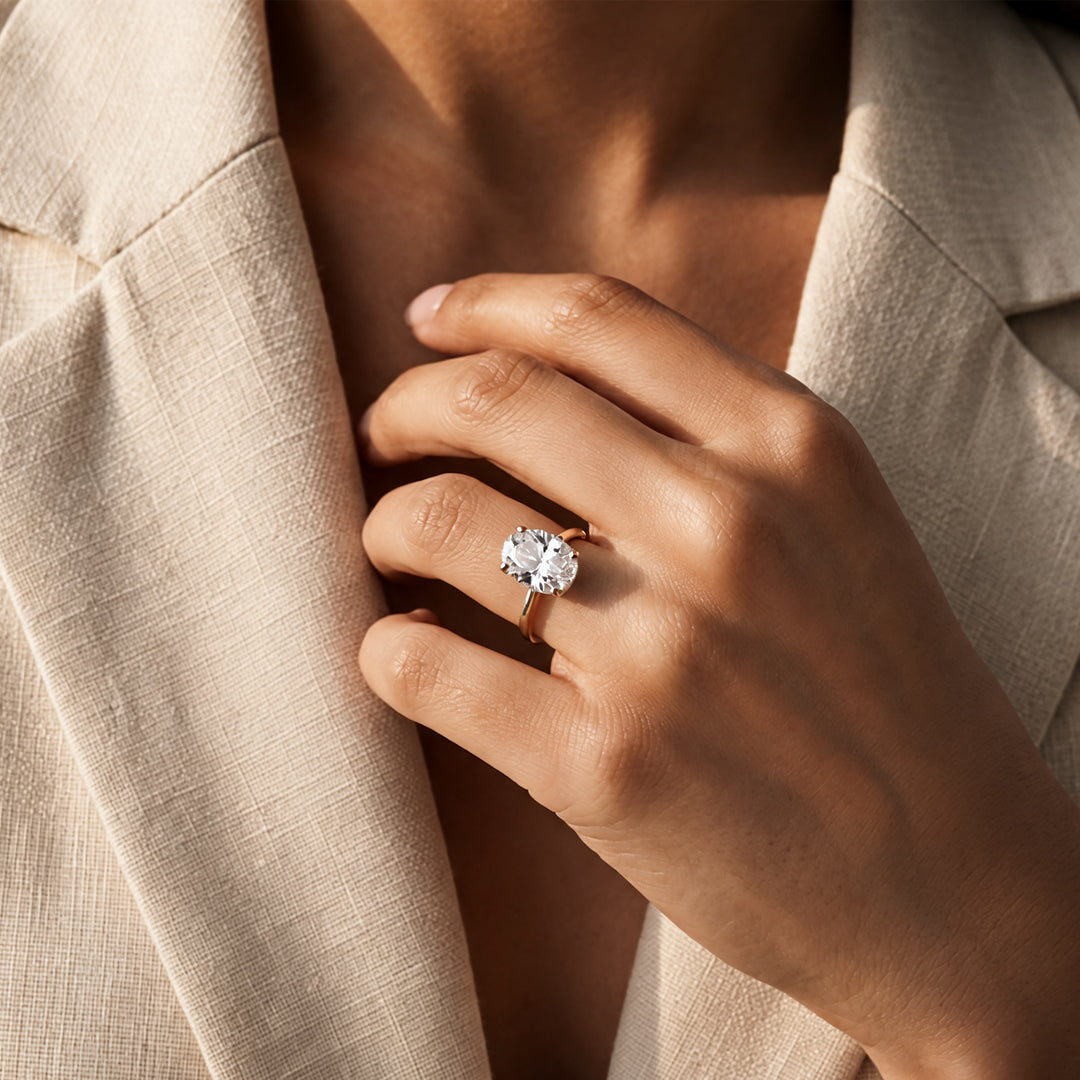 2 carat oval lab grown diamond solitaire engagement ring worn on a hand at AJ's Jewelry in Ridgewood, Queens NY