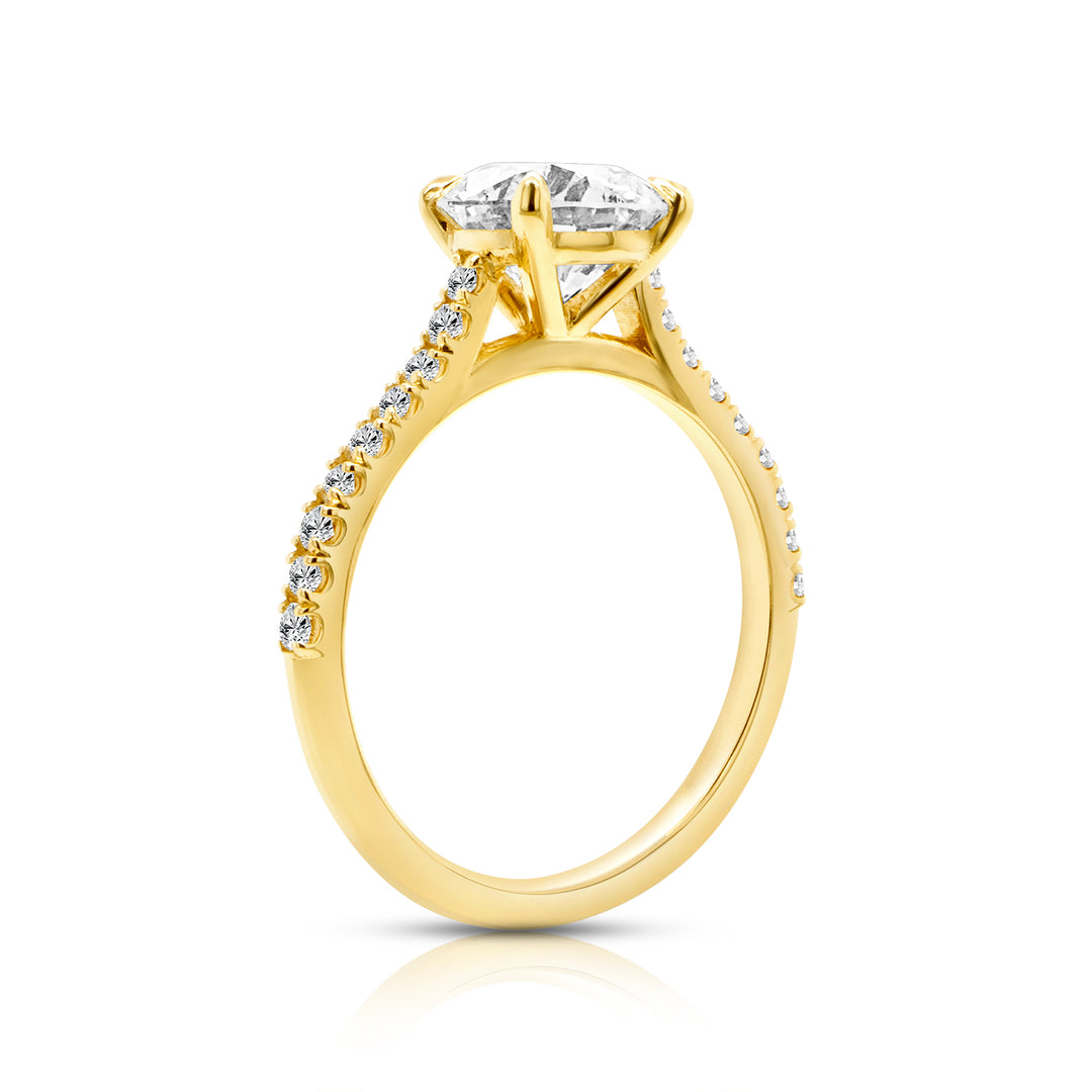 Side profile of a 2ct round pave cathedral lab grown diamond engagement ring showing the soaring cathedral shoulders in 14k yellow gold - AJ's Jewelry Queens NY