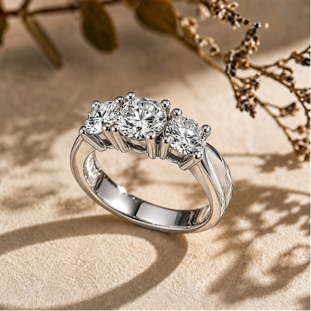 Custom 14KT white gold three-stone lab-grown diamond anniversary ring shown at an angle on a styled display at AJ's Jewelry in Ridgewood, Queens NY