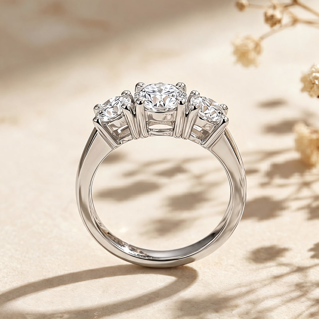 Custom 14KT white gold three-stone lab-grown diamond anniversary ring shown from the side on a styled display at AJ's Jewelry in Ridgewood, Queens NY