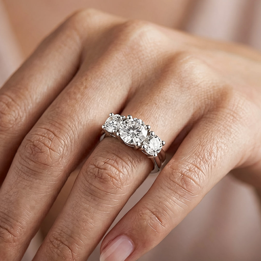 Custom 14KT white gold three-stone lab-grown diamond anniversary ring worn on a hand at AJ's Jewelry in Ridgewood, Queens NY