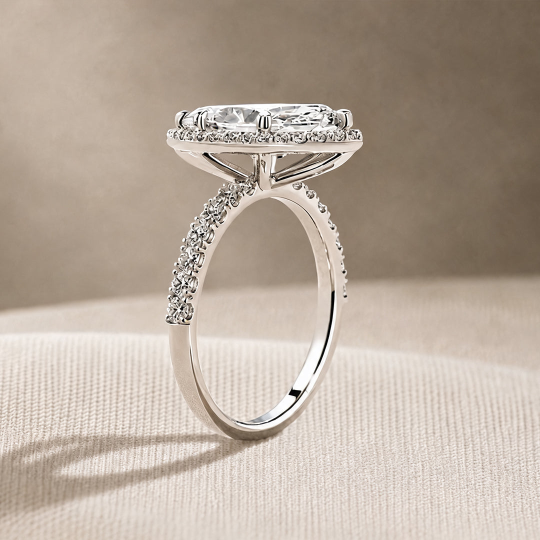 Custom 3 carat marquise lab-grown diamond halo engagement ring shown from the side on a styled display at AJ's Jewelry in Ridgewood, Queens NY