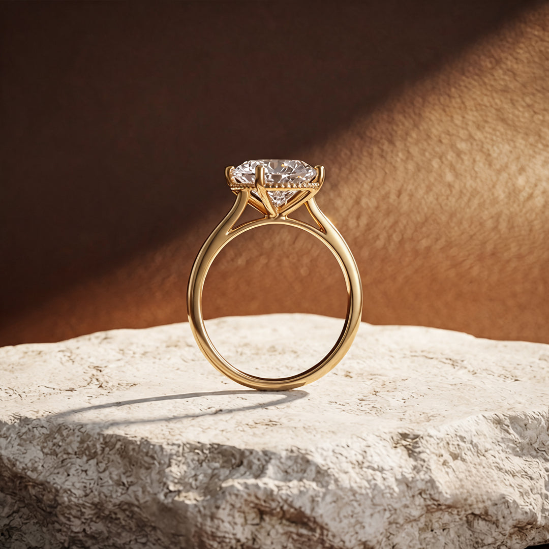 3ct oval lab grown diamond solitaire engagement ring with milgrain halo, side angle on a styled display - AJ's Jewelry Queens NY