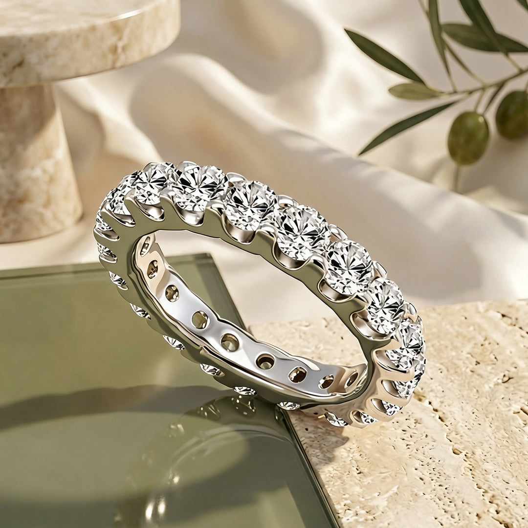 Custom 3 carat platinum lab-grown diamond eternity band shown at an angle on a styled display at AJ's Jewelry in Ridgewood, Queens NY