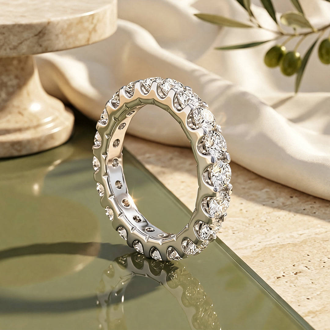 Custom 3 carat platinum lab-grown diamond eternity band shown from the side on a styled display at AJ's Jewelry in Ridgewood, Queens NY