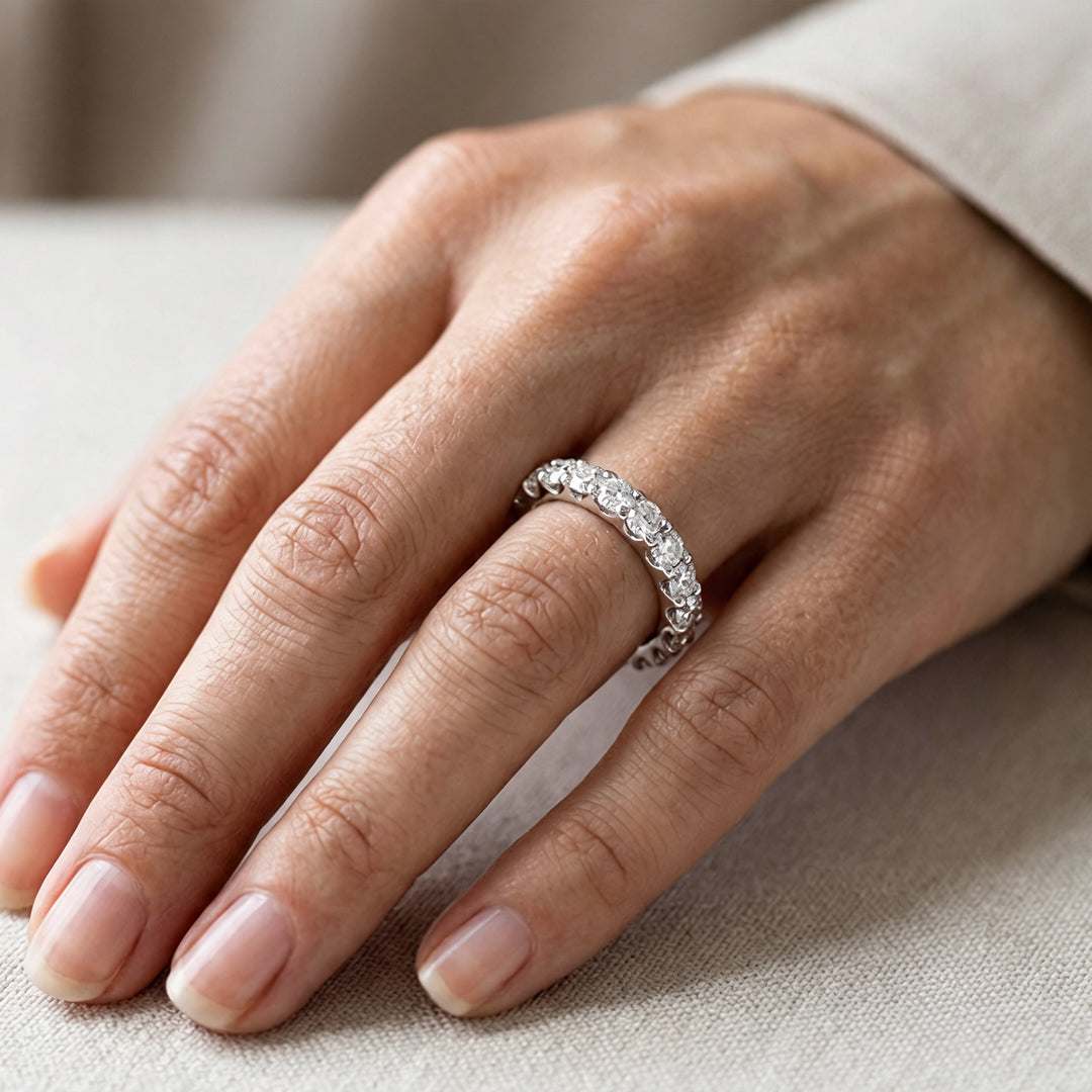 Custom 3 carat platinum lab-grown diamond eternity band worn on a hand at AJ's Jewelry in Ridgewood, Queens NY