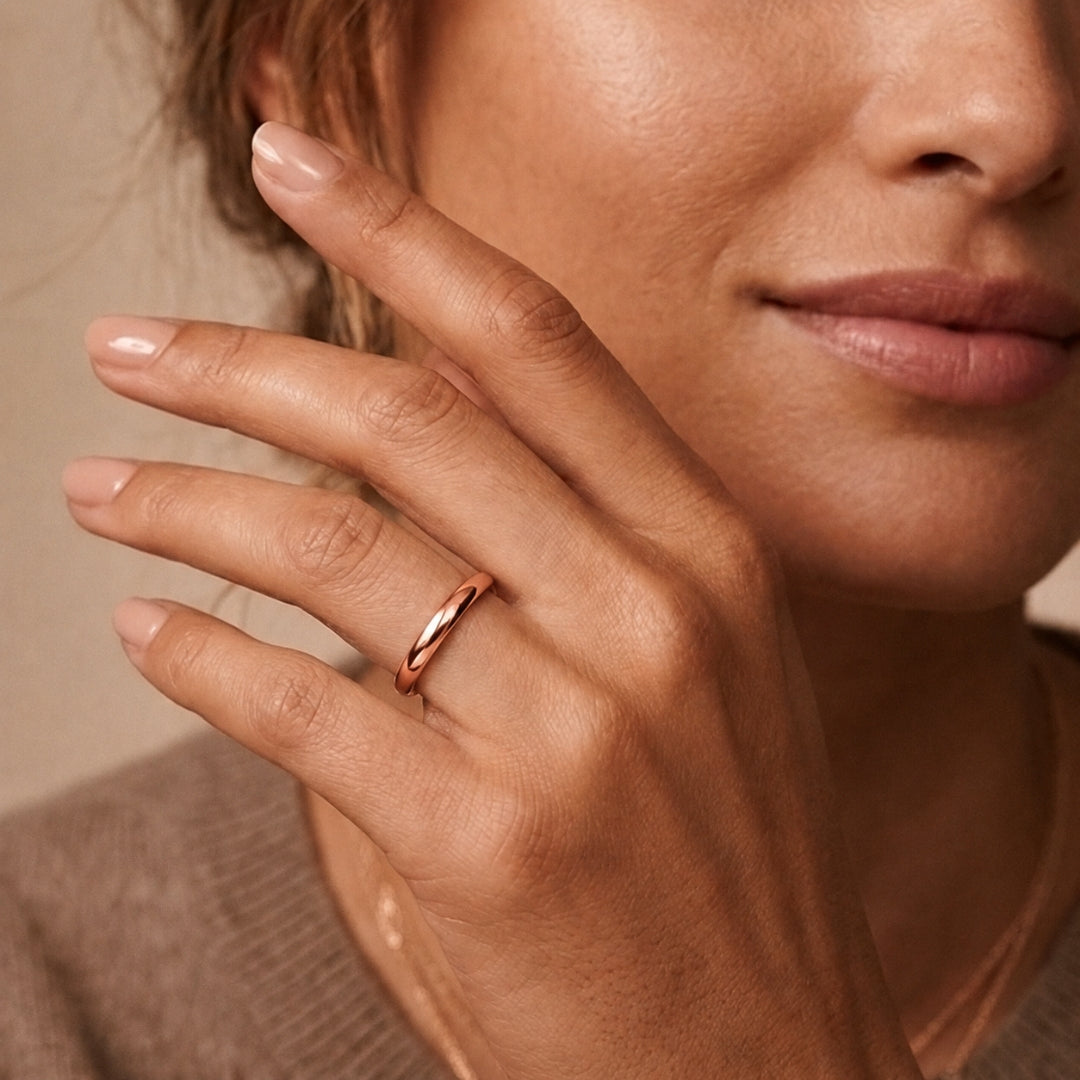3mm 14K rose gold comfort fit wedding band worn on a model's hand, close-up view - AJ's Jewelry, Ridgewood NY
