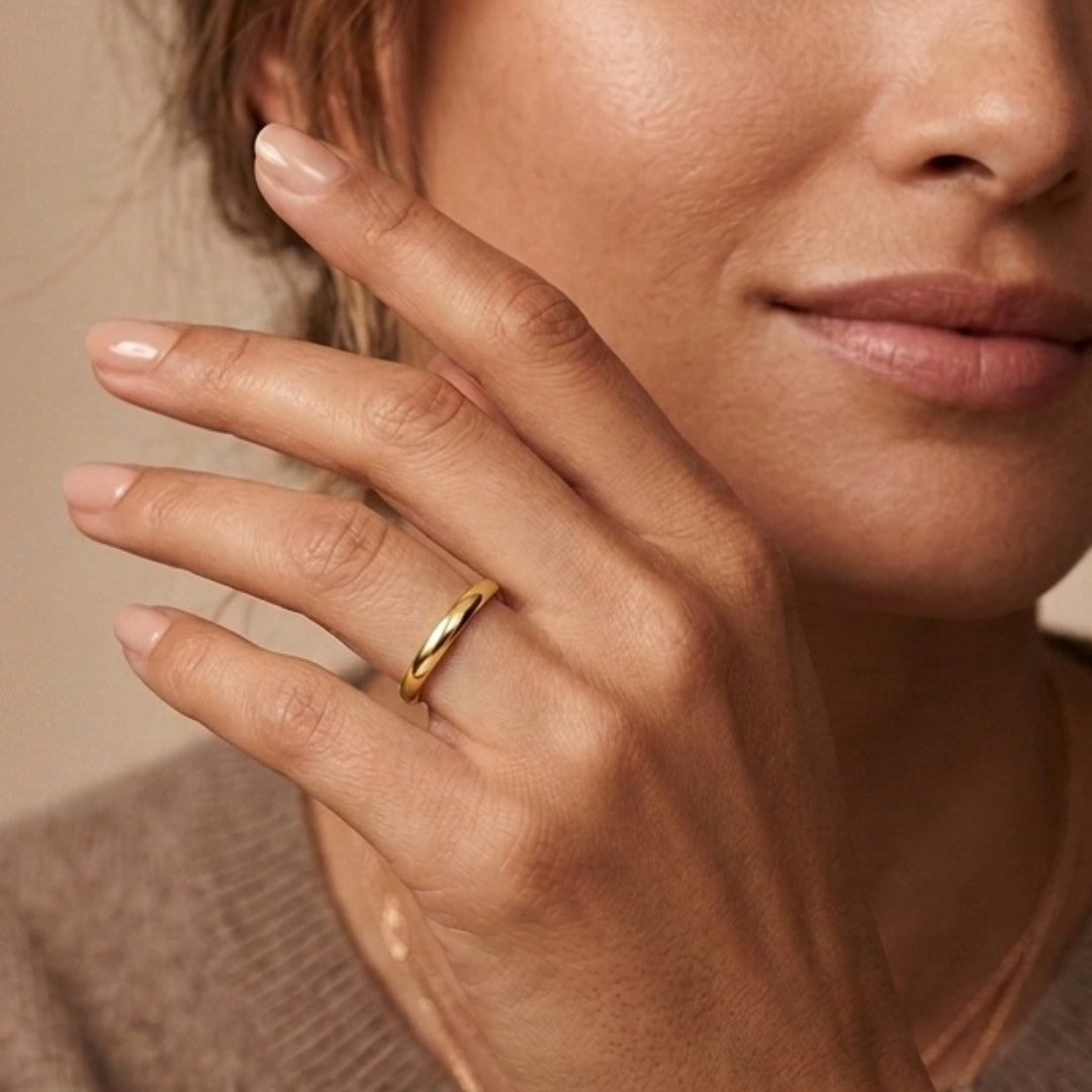 3mm 14K yellow gold comfort fit wedding band worn on a model's hand, close-up view - AJ's Jewelry, Ridgewood NY