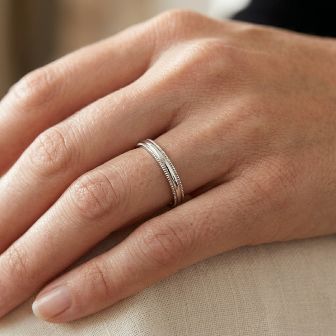 A model wearing the 3mm Sterling Silver Comfort Fit Milgrain Wedding Band