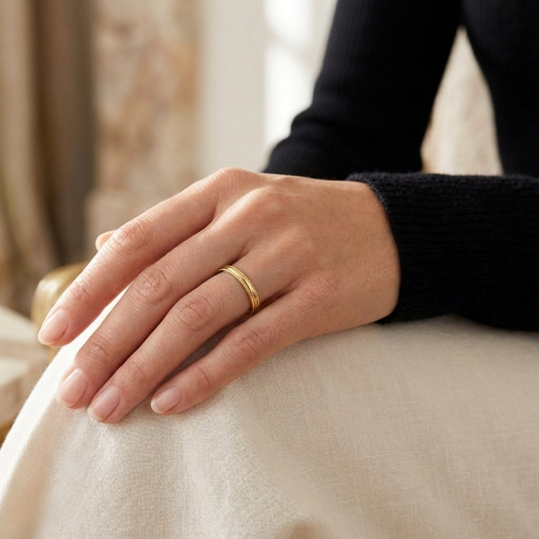 A model wearing the 3mm Yellow Gold Comfort Fit Milgrain Wedding Band