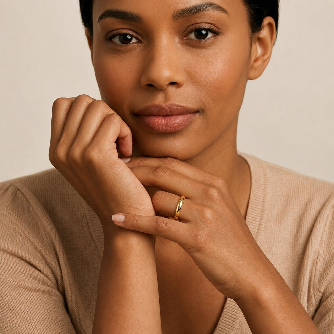 A model wearing the 3mm Slim Half Round Wedding Band in Yellow Gold