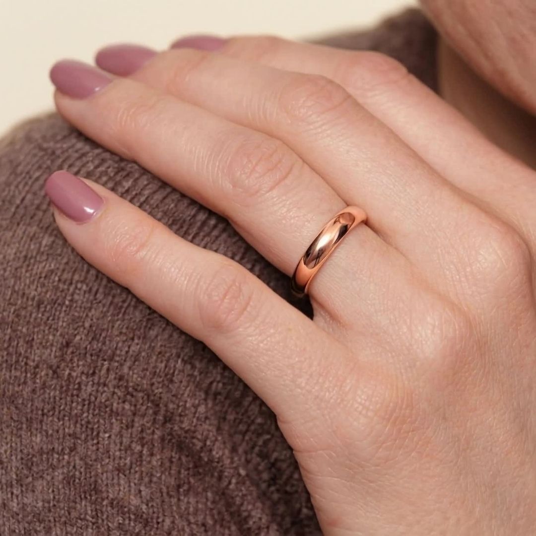 A model wearing the 4mm Slim Half Round Wedding Band in Rose Gold
