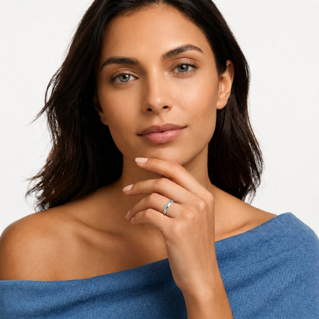 A model wearing the 4mm Sterling Silver Comfort Fit Milgrain Wedding Band