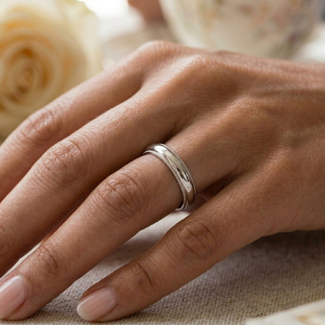 A model wearing the 4mm Sterling Silver Comfort Fit Milgrain Wedding Band