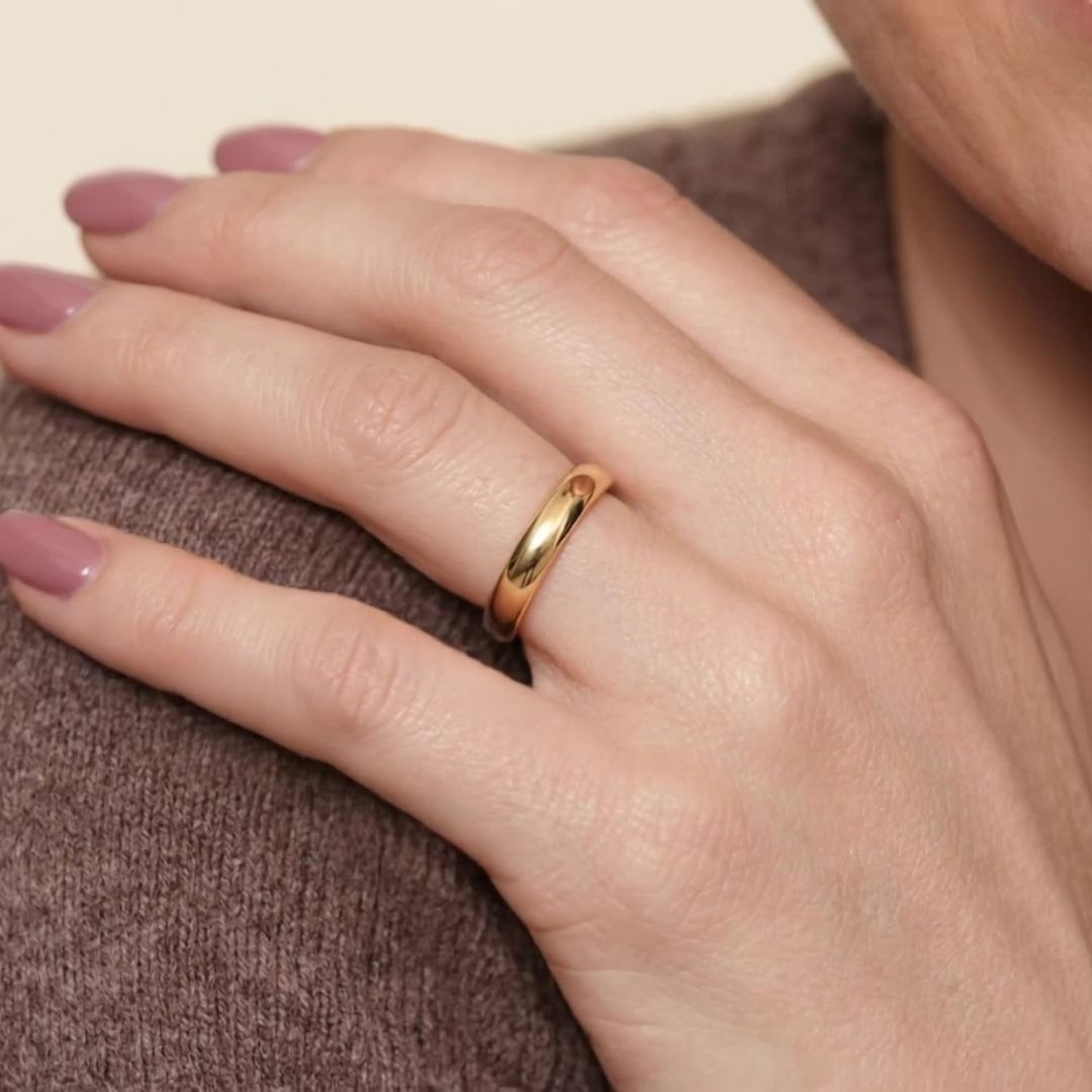 A model wearing the 4mm Slim Half Round Wedding Band in Yellow Gold