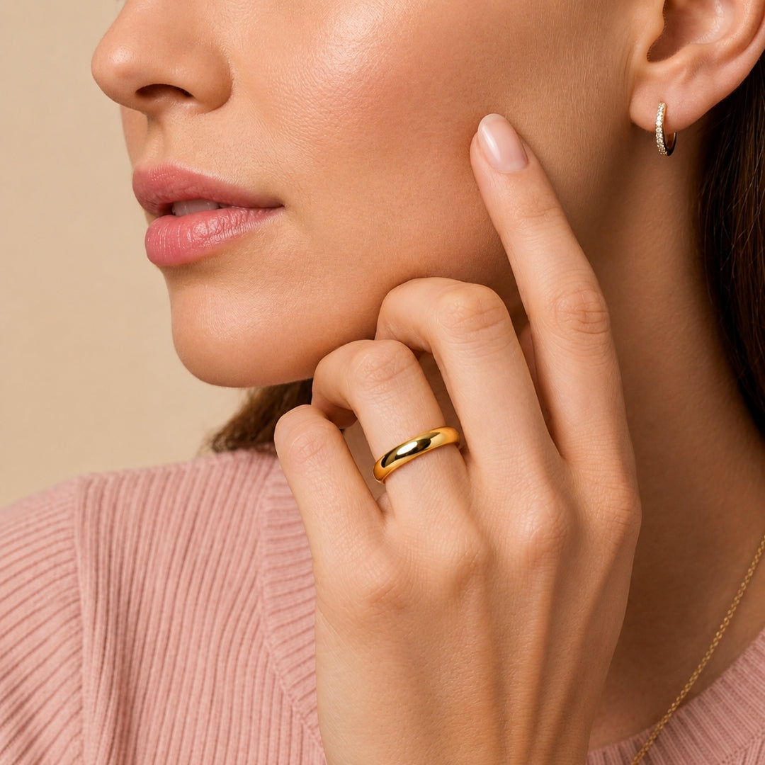 5mm 14K yellow gold comfort fit wedding band worn on a model's hand, close-up view - AJ's Jewelry, Ridgewood NY