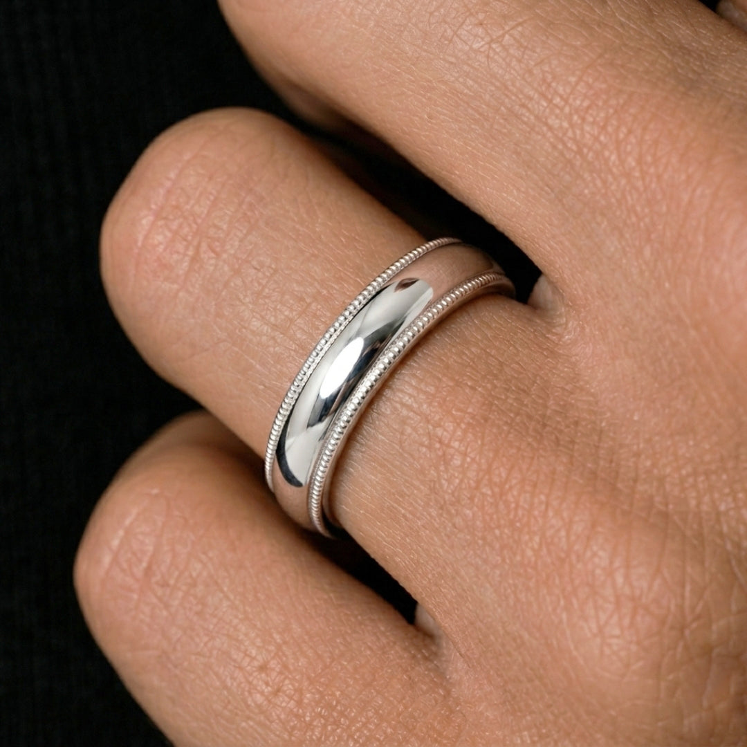 A model wearing the 5mm Sterling Silver Comfort Fit Milgrain Wedding Band