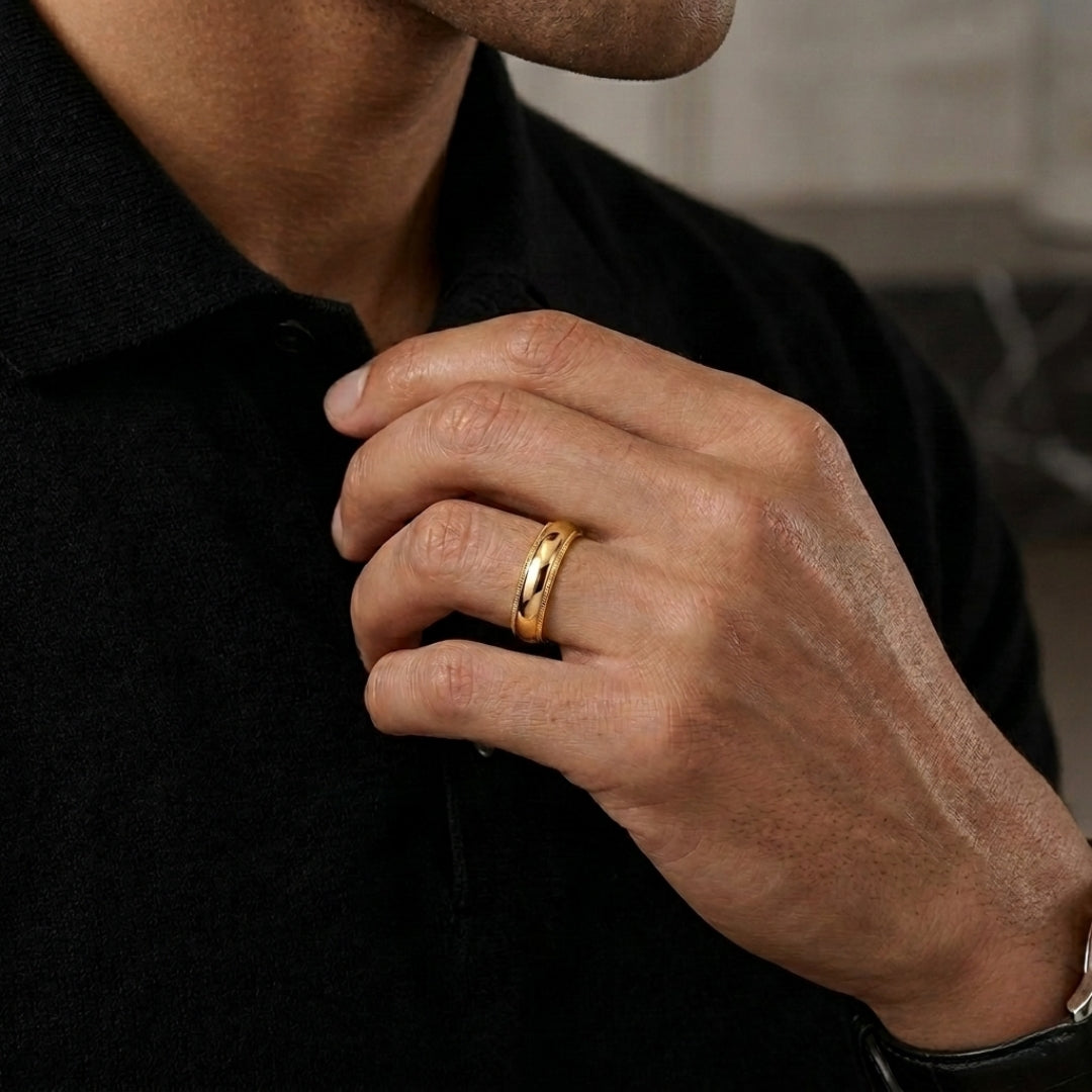 A model wearing the 5mm Yellow Gold Comfort Fit Milgrain Wedding Band