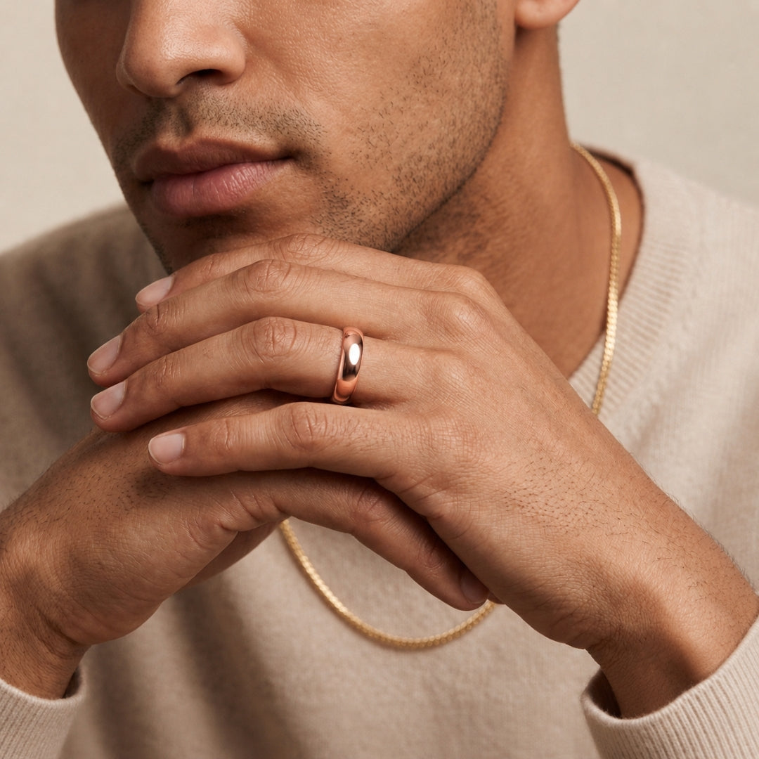 6mm 14K rose gold comfort fit wedding band worn on a model's hand, close-up view - AJ's Jewelry, Ridgewood NY