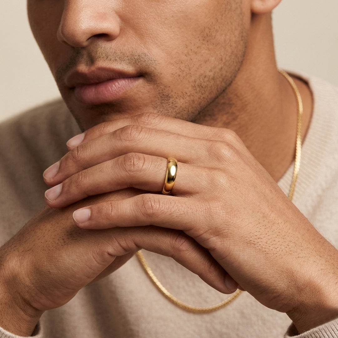 6mm 14K yellow gold comfort fit wedding band worn on a model's hand, close-up view - AJ's Jewelry, Ridgewood NY