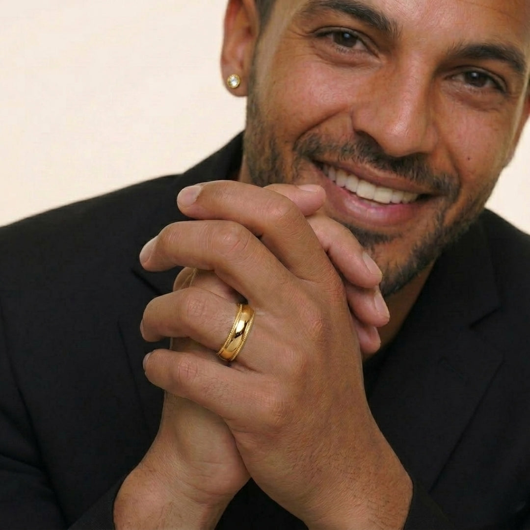 A model wearing the 6mm Yellow Gold Comfort Fit Milgrain Wedding Band