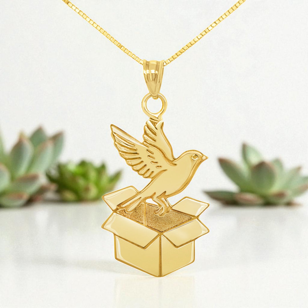 The finished presentation of the 14 Karat Yellow Gold Bird Coming Out of a Box Pendant