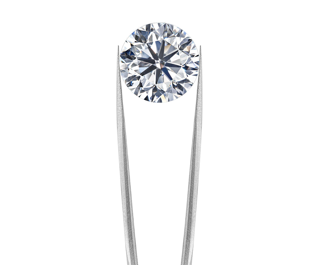 Diamond held by tweezer on a white background