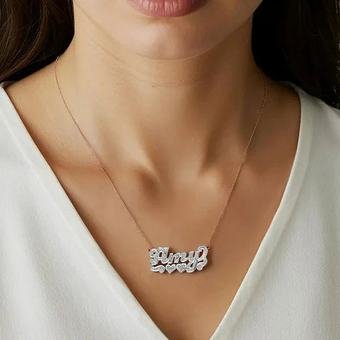 Model wearing the 14 Karat Diamond Cut 3D Name Necklace with Two Hearts in 14K rose gold, name Amy | AJ's Jewelry