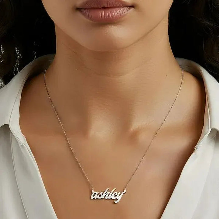Model wearing the 14 Karat Bold Letter Name Necklace in 14K white gold personalized with the name Ashley | AJ's Jewelry