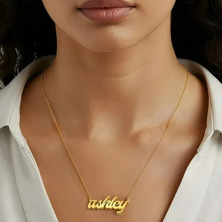 Model wearing the 14 Karat Bold Letter Name Necklace in 14K yellow gold personalized with the name Ashley | AJ's Jewelry