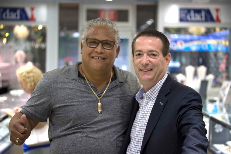 AJ's Jewelry client with the store owner after receiving his custom 14kt gold Castillo San Felipe pendant — Ridgewood Queens NY