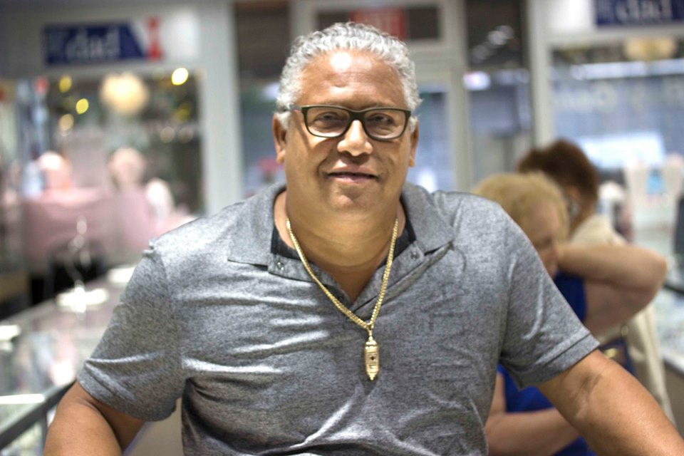 Happy AJ's Jewelry client wearing his finished 14kt yellow gold Castillo San Felipe El Morro pendant — Ridgewood Queens NY