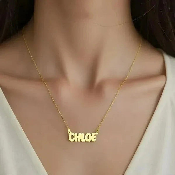 Model wearing the 14 Karat Bubble Letter Name Necklace in 14K yellow gold personalized with the name Chloe | AJ's Jewelry