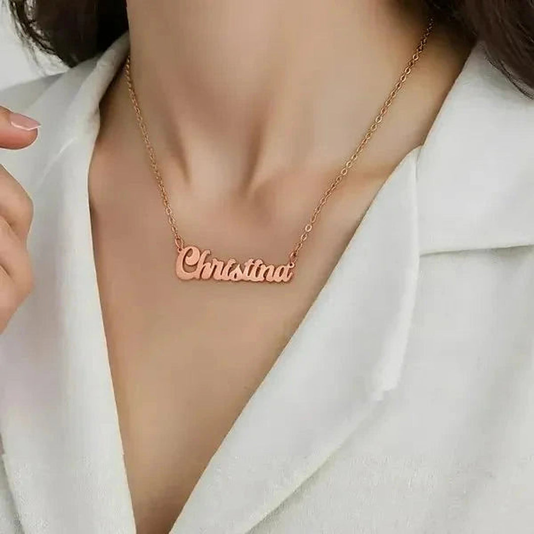 Model wearing the 14 Karat Solid Letter Name Necklace in 14K rose gold personalized with the name Christina | AJ's Jewelry